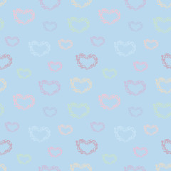 Seamless vector pattern with multicolored cute hearts on a light blue background.