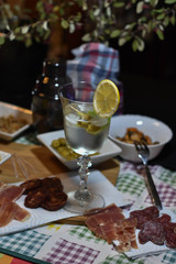 olives floating on the cold vermouth of the glass cup