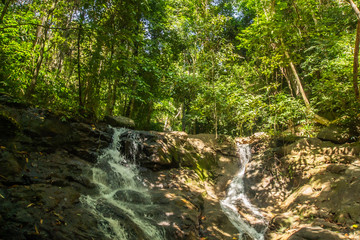 Fototapeta na wymiar Kathu Waterfall in the tropical forest area In Asia, suitable for walks, nature walks and hiking, adventure photography Of the national park Phuket Thailand,Suitable for travel and leisure.
