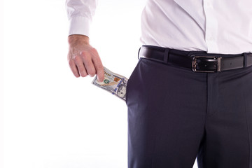 Businessman pulls out a pack of dollars from his trouser pocket closeup on a white background with space for text