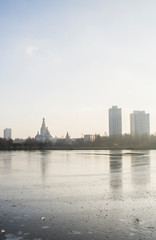 Fototapeta na wymiar Frozen ice lake in the city in the park in winter.