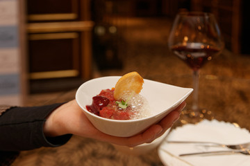 Woman offering steak tartare with froth