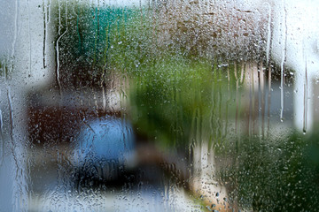 Wet window glass with blurred street view