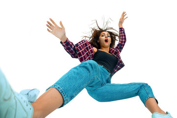 A second before falling. Caucasian young girl falling down in moment with bright emotions and facial expression. Female model in casual clothes. Shocked, scared, screaming. Copyspace for ad. - obrazy, fototapety, plakaty