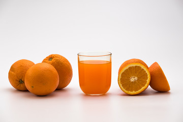 Orange juice in a glass with fresh orange fruits isolated on white Background