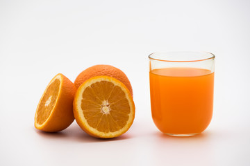 Orange juice in a glass with fresh orange fruits isolated on white Background