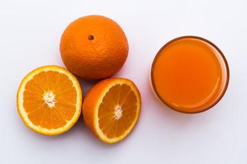 Orange juice in a glass with fresh orange fruits isolated on white Background