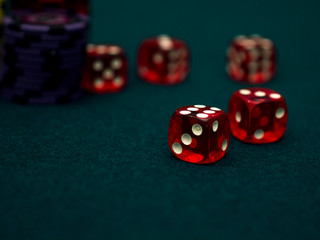 red casino dices on green table. casino game