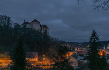 Naklejka premium View over Vimperk town in winter dark cold evening with castle