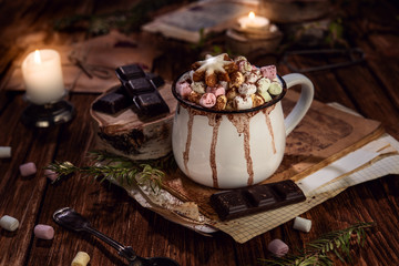 Obraz na płótnie Canvas Hot chocolate with marshmallow on dark background