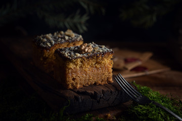 Delicious carrot cake on dark wooden background