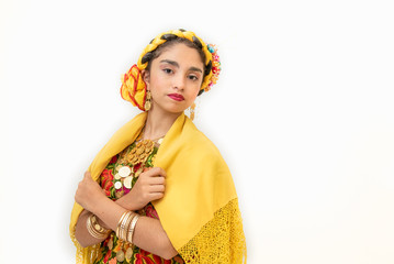 Mexican girl with Mexican Oaxaca dress with multicolored flowers and gold coins, folk costume and culture
