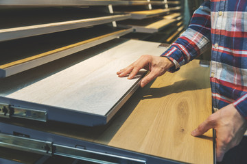 man choosing kitchen countertop materials at interior design shop