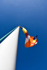 Waving colorful Buddhist Flag in blue sky background 