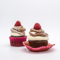 chocolate cupcake with frosting and raspberry garnish