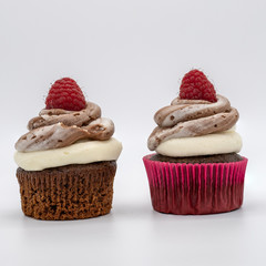 chocolate cupcake with frosting and raspberry garnish