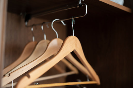 some empty wooden hangers inside the home vintage wardrobe