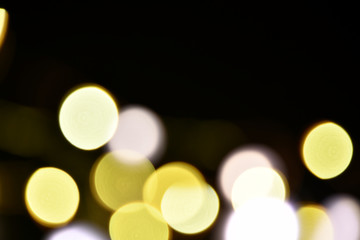 Abstract bokeh background of defocused lights. Merry Christmas and New Year background. Holiday glowing background and wallpaper. Blurred Bokeh.