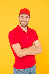 Always on time. Dedicated to your business. Service delivery. Salesman and courier career. Courier and delivery service. Postman delivery worker. Man red cap yellow background. Delivering purchase