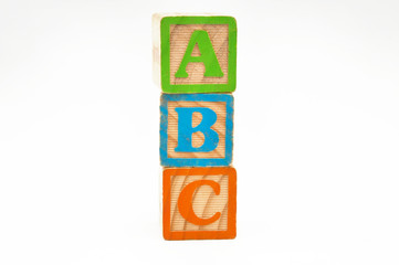 wooden cube blocks stacked with the letters abc isolated on a white background