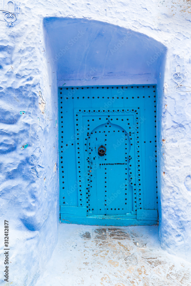 Wall mural traditional typical moroccan architectural details in chefchaouen, morocco, africa beautiful street 