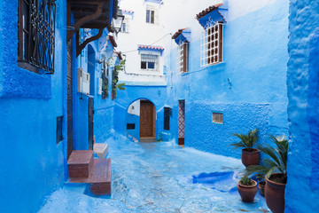 Traditional typical moroccan architectural details in Chefchaouen, Morocco, Africa Beautiful street of blue medina with blue walls and decorated with various objects (pots, jugs). A city with narrow, 