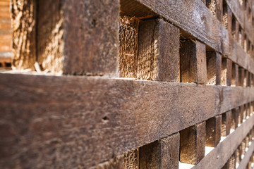 Close up wooden fence with square cells.
