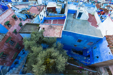 Fototapeta na wymiar Traditional typical moroccan architectural details in Chefchaouen, Morocco, Africa Beautiful street of blue medina with blue walls and decorated with various objects (pots, jugs). A city with narrow, 