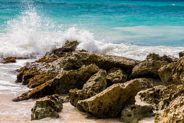 Waves crashing on rocks on a beach