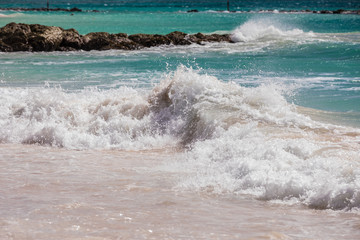 Waves crashing on rocks on a beach