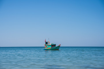 Wooden motor boat with a Vietnamese flag