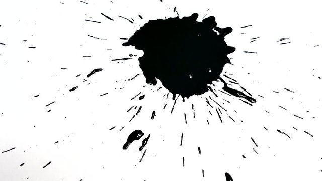 Black spot on a white background. Dripping ink drops on a white piece of paper.