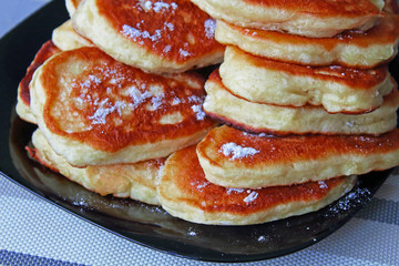 Fresh pancakes on a plate on the table. Close-up. Background.