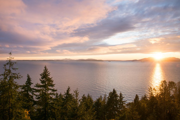 colorful sunset from cliff with a view over the sea forest and mountains , America near Seattle