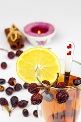 Rosehip tea. Alternative treatment for colds and flu. Dried rosehip. Glass with rosehip tea. Treatment of chills. Medicinal plants.