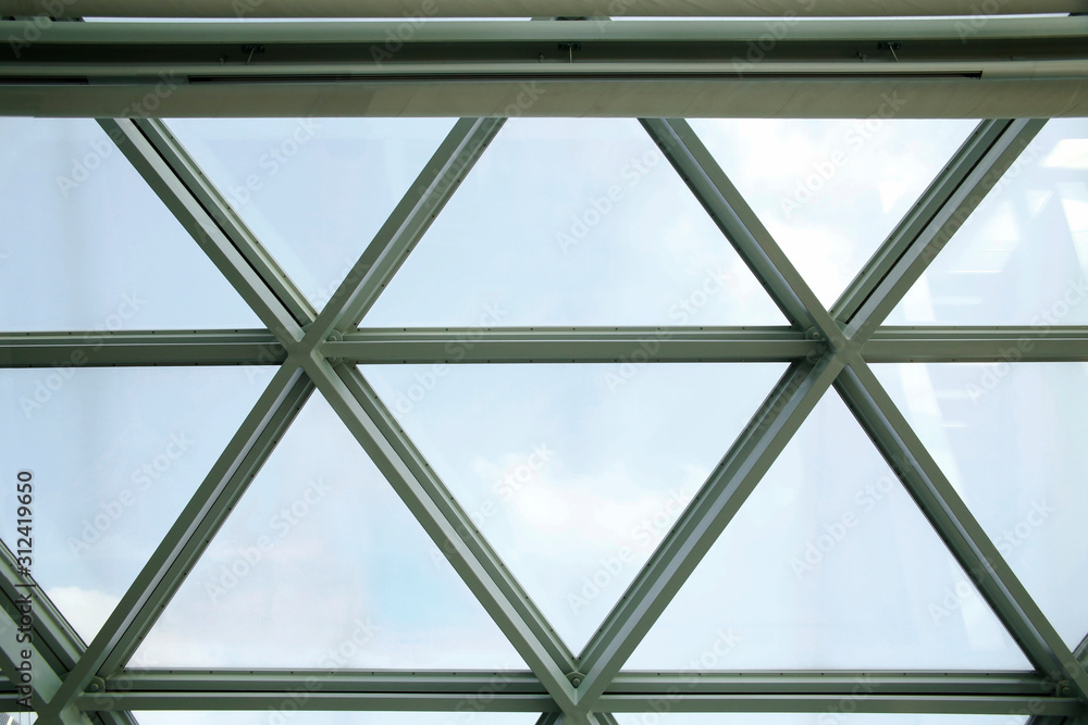 Poster transparent ceiling with triangular glass units. structural glazing. close-up photo of modern archit