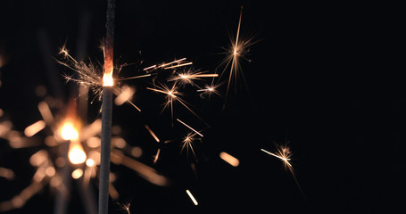 Firework sparkler burning on black background. Merry Christmas and happy new year celebration