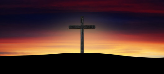 wooden cross silhouette at sunrise