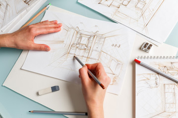 Interior designer making hand drawing pencil sketch of a bathroom