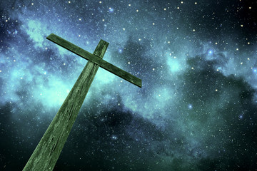 wooden cross under stars in the night sky