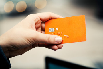 Hands holding credit card - close up