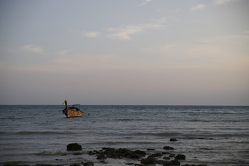 Fototapeta premium Sunset in the beach with a boat, Thailand 