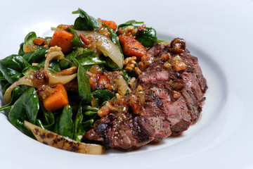 meat with vegetables on white plate