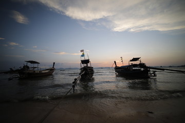 Sunset in the beach with a boat, Thailand 