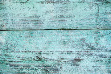 Old weathered wood plank painted in blue.