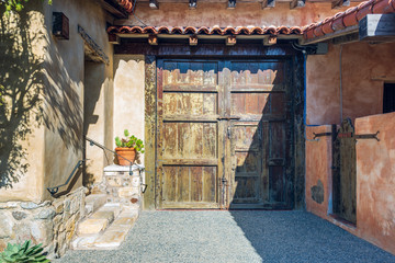 old wooden doors in an adobe wall