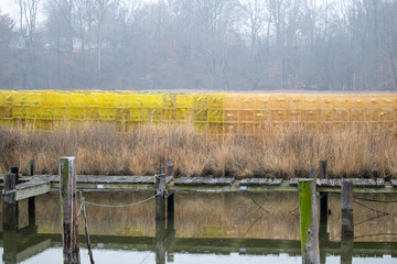 crab pots stacked up along a creek in winter.  southern maryland calvert county usa - obrazy, fototapety, plakaty