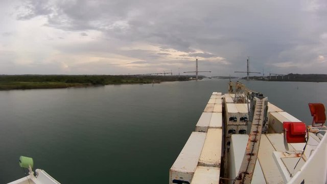 Panama city / Panama - December 31, 2017: Timelapse video made from bridge of reefer cargo ship sailing in Panama canal meeting two vessels - container ship and bulker