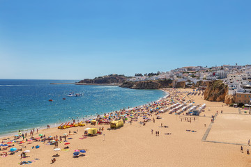 Fototapeta na wymiar Famous tourist beach with fishermen in Albufeira, Portugal.