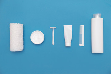 Body and skin hygienic care toiletry products, in white packaging on a blue background. Flat lay. Copy space